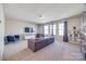 Well-lit living room featuring a sofa, two blue chairs, a TV, and multiple windows at 975 Shorthill Ln, Fort Mill, SC 29715