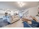 Open-concept living room with kitchen view featuring a large island, breakfast bar, and modern appliances at 975 Shorthill Ln, Fort Mill, SC 29715