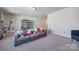 A cozy living room with a gray sofa, shelving, and ample space for relaxation and entertainment at 975 Shorthill Ln, Fort Mill, SC 29715