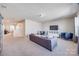 Spacious living room featuring a large sofa, blue chairs, a TV, and plenty of natural light at 975 Shorthill Ln, Fort Mill, SC 29715