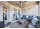 Cozy covered patio featuring comfortable gray seating, ceiling fan, and stylish decor at 975 Shorthill Ln, Fort Mill, SC 29715