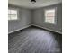 Bedroom showcasing wood-look flooring, neutral walls, and two windows at 1064 S Stonewall Ave, Rock Hill, SC 29732