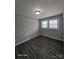 Cozy bedroom with wood-look floors, neutral walls, and natural light from two windows at 1064 S Stonewall Ave, Rock Hill, SC 29732