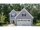 Gray house with white garage doors and landscaping at 1163 Ryan Meadow Dr, Monroe, NC 28110