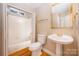 Bathroom with a pedestal sink, toilet, and shower/tub combo at 11805 Prestmoor Ct, Charlotte, NC 28262