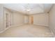 Spacious bedroom featuring a ceiling fan and carpet at 11805 Prestmoor Ct, Charlotte, NC 28262