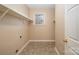 Functional laundry room with shelving and tile flooring at 11805 Prestmoor Ct, Charlotte, NC 28262