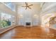 Two-story living room with hardwood floors, built-in shelves, and fireplace at 11805 Prestmoor Ct, Charlotte, NC 28262