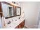 Bathroom with double vanity and decorative mirrors at 13234 Hidcote Ct, Huntersville, NC 28078