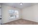 Bright bedroom featuring a large window and neutral walls at 13234 Hidcote Ct, Huntersville, NC 28078