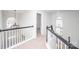 Upstairs hallway with carpet and multiple windows at 13234 Hidcote Ct, Huntersville, NC 28078