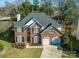 Brick house with two-car garage and landscaped yard at 13234 Hidcote Ct, Huntersville, NC 28078