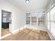 Sunroom with walls of windows and hardwood floors at 13234 Hidcote Ct, Huntersville, NC 28078