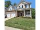 Charming two-story home with a brick facade, white trim, black shutters, and a well-manicured lawn at 141 Silverspring Pl, Mooresville, NC 28117