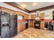 Kitchen features wood cabinets, black appliances, and wood-look vinyl flooring at 141 Silverspring Pl, Mooresville, NC 28117