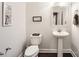 Modern powder room with pedestal sink and dark wood floors at 141 Silverspring Pl, Mooresville, NC 28117