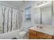 Clean bathroom with shower/tub combo and wood vanity at 14311 Riding Hill Ave, Charlotte, NC 28213