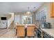 Dining area with wooden table, tan chairs, and access to a patio at 14311 Riding Hill Ave, Charlotte, NC 28213