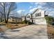 Two-story house with driveway, landscaping, and a basketball hoop at 14311 Riding Hill Ave, Charlotte, NC 28213