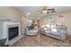 Living room with hardwood floors, fireplace, and comfortable seating at 14311 Riding Hill Ave, Charlotte, NC 28213