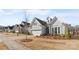 View of a well-kept home showcasing a well-manicured lawn and beautiful landscaping at 14531 Crosswater Ln, Charlotte, NC 28278