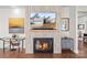 Living room fireplace with mounted TV, hardwood flooring, and neutral wall colors at 14531 Crosswater Ln, Charlotte, NC 28278