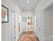 Inviting hallway with hardwood floors provides access to various rooms in the house at 14531 Crosswater Ln, Charlotte, NC 28278