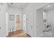 Bright hallway leads to bathroom, laundry room, and other rooms with beautiful wood floors and white trim at 14531 Crosswater Ln, Charlotte, NC 28278