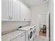 Bright laundry area with modern appliances, granite counters, and plenty of cabinet storage at 14531 Crosswater Ln, Charlotte, NC 28278