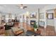 Spacious living room features a fireplace, ceiling fan, hardwood floors and flows into the kitchen and dining area at 14531 Crosswater Ln, Charlotte, NC 28278