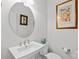 Stylish powder room features a sleek pedestal sink and decorative touches at 14531 Crosswater Ln, Charlotte, NC 28278