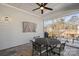 Outdoor screened porch with table and chairs for relaxing or entertaining, includes ceiling fan at 14531 Crosswater Ln, Charlotte, NC 28278