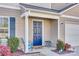 Inviting front entry with a navy blue door and small porch at 1529 Cannan Mountain Dr, Newton, NC 28658