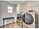 Laundry room with modern washer and dryer, and folding table at 1529 Cannan Mountain Dr, Newton, NC 28658