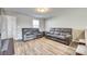 Living room with gray reclining sofas and wood-look floors at 1529 Cannan Mountain Dr, Newton, NC 28658