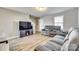 Living room featuring gray sofas, wood floors, and a large TV at 1529 Cannan Mountain Dr, Newton, NC 28658