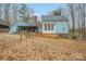 Home's back features a large yard and wooded area at 161 Moore Haven Dr, Salisbury, NC 28147