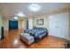 Bright bedroom with hardwood floors, a comfortable bed and built-in shelving at 161 Moore Haven Dr, Salisbury, NC 28147