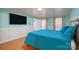 Comfortable bedroom with teal bedding and hardwood floors at 161 Moore Haven Dr, Salisbury, NC 28147