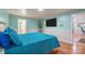 Spacious bedroom with a wall-mounted TV and teal bedding at 161 Moore Haven Dr, Salisbury, NC 28147