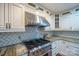 Stainless steel range hood and gas cooktop in a white kitchen at 161 Moore Haven Dr, Salisbury, NC 28147