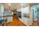 White kitchen with double ovens, granite counters, and breakfast bar at 161 Moore Haven Dr, Salisbury, NC 28147