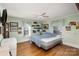 Spacious bedroom with hardwood floors, ceiling fan, and train themed decor at 1979 Charlotte Hwy, Mooresville, NC 28115