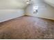 Bright bedroom with window, carpet, and neutral walls at 2219 Lochview St, Pineville, NC 28134