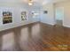 Bright bedroom featuring hardwood floors and multiple windows at 2219 Lochview St, Pineville, NC 28134