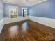 Bright bedroom with hardwood floors and blue walls at 2219 Lochview St, Pineville, NC 28134