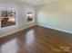 Well-lit bedroom with hardwood floors and green walls at 2219 Lochview St, Pineville, NC 28134