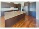 Kitchen with island, stainless steel appliances, and hardwood floors at 2219 Lochview St, Pineville, NC 28134