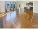 Bright living room with hardwood floors and kitchen view at 2219 Lochview St, Pineville, NC 28134