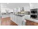 Spacious kitchen with white cabinets, granite island, and double ovens at 320 Belwood Dr, Belmont, NC 28012